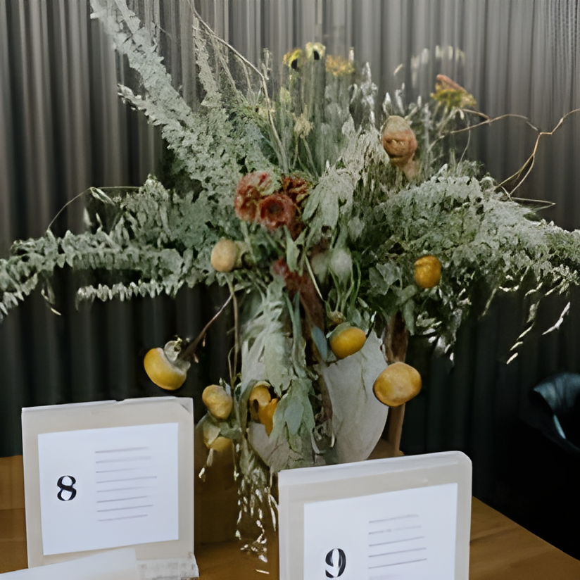 Dried floral centerpiece with craspedia at the venue